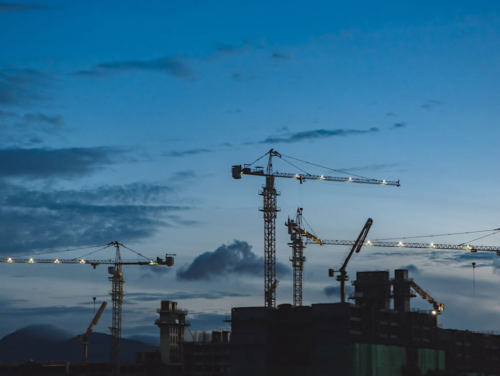 evening skyline cranes working